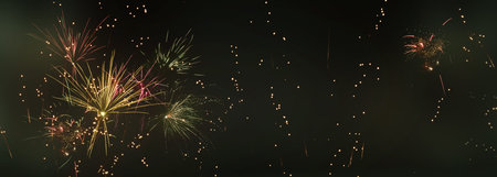 Colorful sparkling fireworks and silver stars on dark night sky. Concept background for new years...