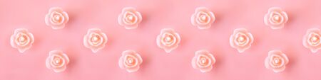 Seamless pink background pattern with burning scented candles. Endless texture for wrapping paper, fabric patterns and design. Top view.の写真素材