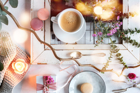 Mothers day decoration in bright vintage style with colorful macarons and a cup of coffee. Floral...