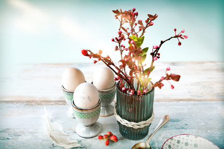 Breakfast scene with easter eggs. Still life in vintage style with pastel colored eggs and fresh...