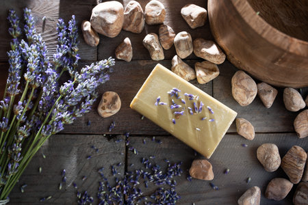 Decoration for a lavender aromatherapy. Atmospheric flat lay photography on dark rustic wood with short deep of field and space for text.の写真素材