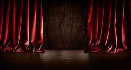 Dark empty stage scene with red velvet curtain. Horizontal background for anniversaries, birthdays, concerts, shows and special occasions. Space for text.の写真素材