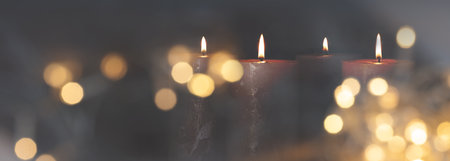 Christmas candle light with blurred golden bokeh for religious ritual and funeral service or spiritual meditation. Background for peaceful mind and soul with space for text.の写真素材