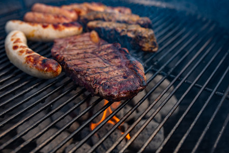 Spicy marinated meat on round charcoal grill. Close up with short depth of field. Barbecue meat