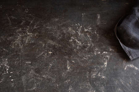White floured kitchen top with black linen cloth. Background for kitchen works.の写真素材