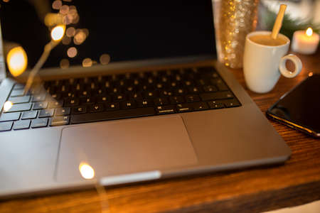 Christmas shopping on Internet with laptop and smartphone. Buy easily and conveniently from home. Close-up with short depth of field.の写真素材