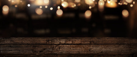 Illuminated old weathered wooden counter in a bar with bokeh lights. Background for decorations and...