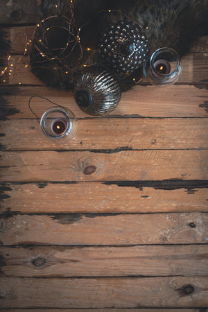 Mystical dark christmas decoration on vertical wooden background with lights and christmas balls....