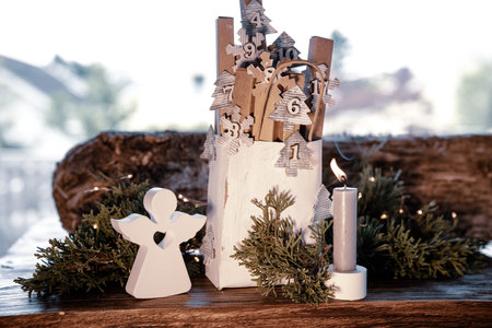 Homemade advent calendar made of cardboard. Small cardboard boxes in a paper bag decorated on rustic wood. Sustainable Christmas packaging. Background for an eco friendly Christmas surprise.の写真素材