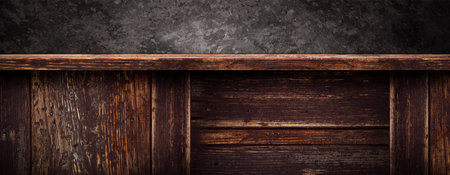 Empty dark rustic wooden counter in front of a black stone wall. Background for product display with space for text.の写真素材