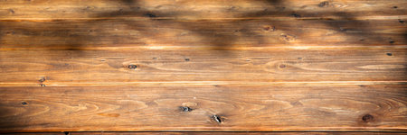 Rustic bright brown wooden board texture or table texture. Empty long horizontal wooden background for decorations and space for text.の写真素材