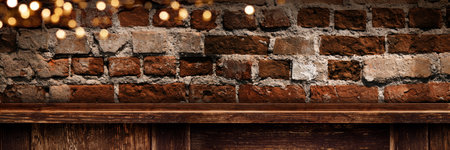 Old brick wall with wooden counter and golden bokeh lights. Horizontal vintage background with warm glow and dimly lit environment for atmospheric decorations with space for text.の写真素材
