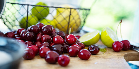 Fresh red cherries for making homemade jam. Sugar, lime and lemon for preserving fruit. Background for homemade jam.の写真素材