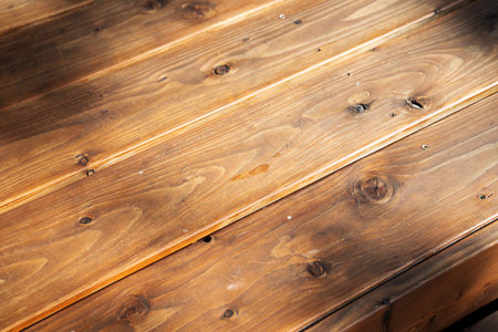 Background texture of wooden planks. Rustic diagonal wooden surface in a vintage color tone with shadows.の写真素材
