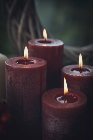 Ceremonial scene with burning candles. Traditionally luminous symbol of holidays and all saints' day. Vertical background with a peaceful and tranquil atmosphere. Space for text.の写真素材