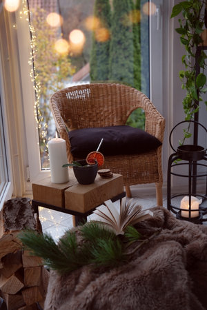 Cozy reading nook with comfortable furnishings and natural light. Vertical background for leisure and relaxation.の写真素材