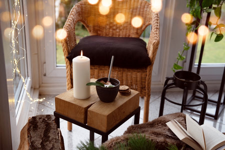 Cozy reading nook with comfortable furnishings and natural light. Background for leisure and relaxation.の写真素材