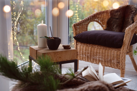 Cozy reading nook with comfortable furnishings and natural light. Background for leisure and relaxation.の写真素材