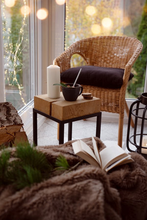 Cozy reading nook with comfortable furnishings and natural light. Vertical background for leisure and relaxation.の写真素材