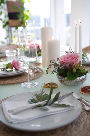 A festively set table for a wedding dinner. Tastefully decorated restaurant background with short depth of field.の写真素材