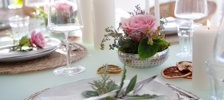 A festively set table for a wedding dinner. Tastefully decorated restaurant background with short depth of field.の写真素材