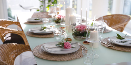 A festively set table for a wedding dinner. Tastefully decorated restaurant background with short...
