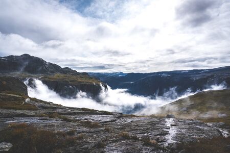 Foggy day in the mountains fjords in first days of autumnの写真素材