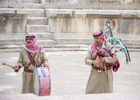 Jordanian singers in Jerash on 26 December 2021 playing bagpipes to attract touristsのeditorial素材