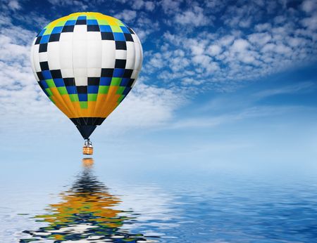 Hot air balloon flying in blue skyの写真素材