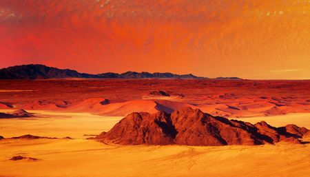 Desert fantasy with red sunset, birds-eye viewの写真素材