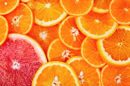 Background of sliced oranges and grapefruitの写真素材
