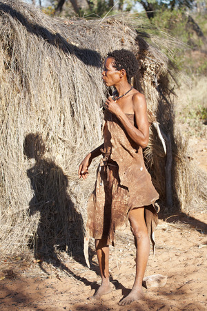 NAMIBIA - MAY 06: Bushman woman near hut on May 6, 2007 in Namibia, Kalahari Desert. Bushmen are an indigenous people of southern Africa that living in Namibia, Botswana and some another countriesのeditorial素材