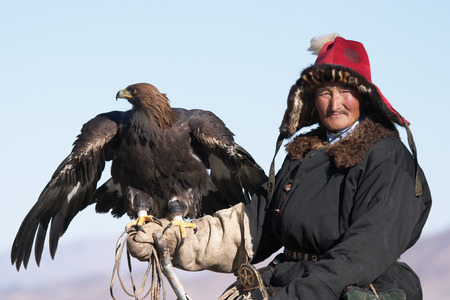 Old-man eaglehunter berkutchi with golden eagle, Mongoliaのeditorial素材