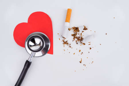 Concept World No Tobacco Day, Stethoscope, Love Paper and a cigarette damaged with isolated white backgroundの写真素材