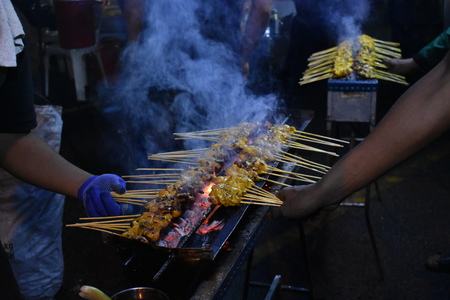 Malaysia local food sate or satay on grill with smoke photo taken in Shah Alam, Malaysiaのeditorial素材