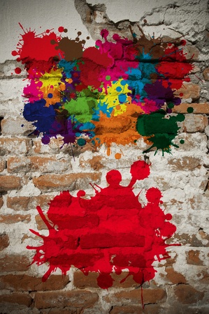 Colored abstract blot background on old brick wallの写真素材