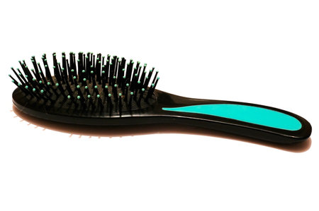 Comb made from black and turquoise plastic looks like a small hedgehog