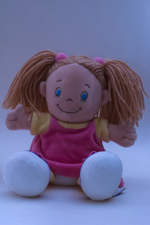 Little rag-doil named Masha merryly smiles and poses to the photographerの写真素材