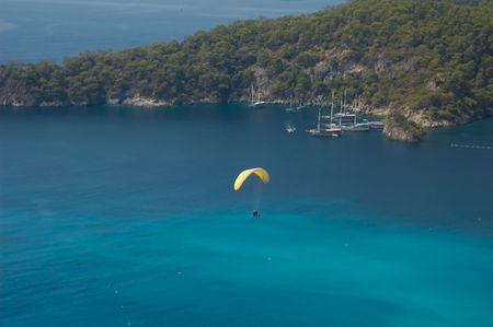Free flight of bold paraglider over the Mediterranean seaの写真素材