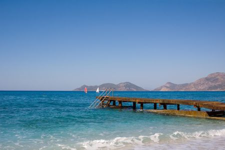 Photo of planked footway goes far in the seaの写真素材