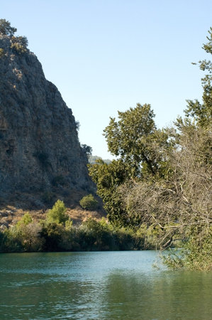 Photo of river bend rounded by mountains and trees