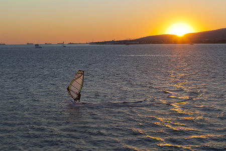 Windsurfer against the setting sun in Gelendzhik Bay. Gelendzhik, Krasnodar region, Russiaの写真素材