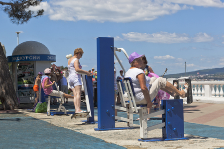 People engaged physical activity at street simulators on the promenade of the resort of Gelendzhik, Krasnodar region, Russiaのeditorial素材