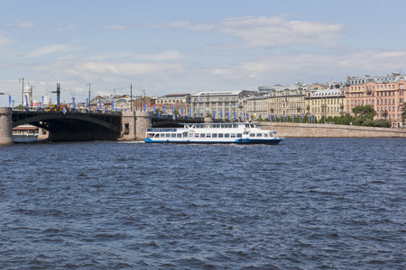 Two-deck motor ship Moscow-55 runs along the Neva River against the background of the Exchange Bridge and Mytninskaya Embankment in St. Petersburg. Petersburg, Russiaのeditorial素材
