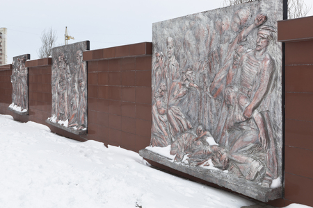 Wall with bronze, bas-reliefs, depicting the tragic events of wartime at the memorial complex of Krasnaya Gorka in the city of Evpatoria, Crimea, Russiaのeditorial素材