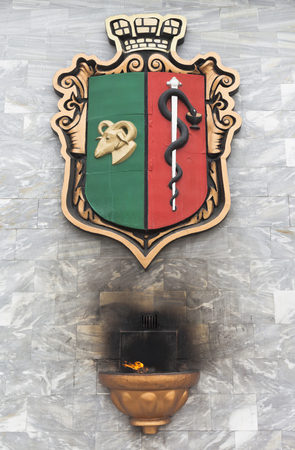 Evpatoria, Crimea, Russia - February 28, 2018: The coat of arms of Evpatoria and the fire of the goddess of the home of Hestia on the memorial wall in honor of the 2500th anniversary of the city, Crimeaのeditorial素材
