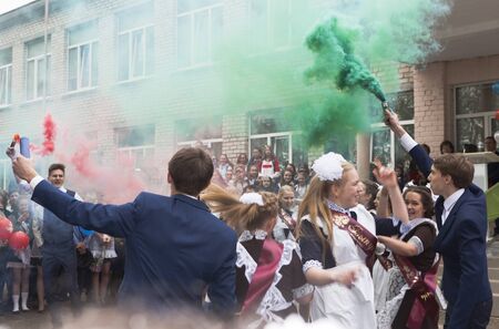 Verkhovazhye, Vologda region, Russia - May 23, 2019: Graduate dance with smoke fireworks at the holiday last callのeditorial素材