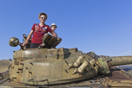 Taman, Temryuk district, Krasnodar region, Russia - July 17, 2019: Children on the tower of the T-64 tank in the ethnographic complex Ataman. Taman of the Temryuk district of the Krasnodar regionのeditorial素材