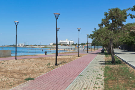 Saki, Crimea, Russia - July 23, 2020: Embankment along the shore of the Saki medicinal lake opposite...