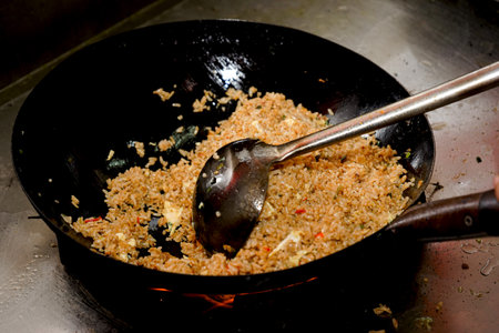 Fried rice in a pan with a spoon, close-upの素材